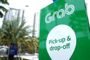 Grab banner showing pick-up and drop-off indicating a personal loan for grab drivers in Singapore which will enable them to drive more or even less