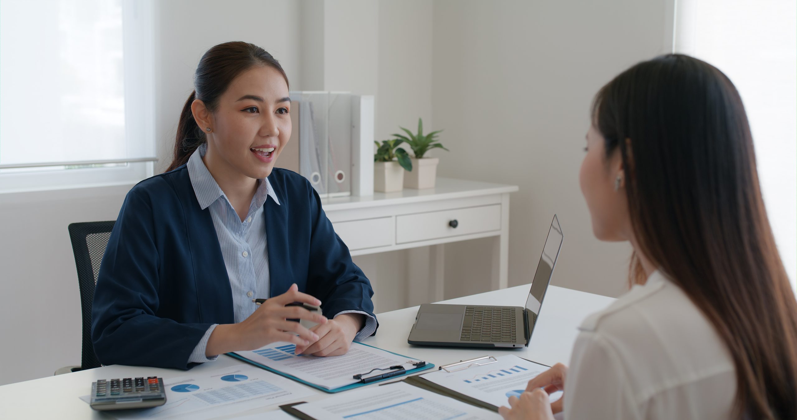 A loan officer explaining a monthly loan's contract from top to bottom