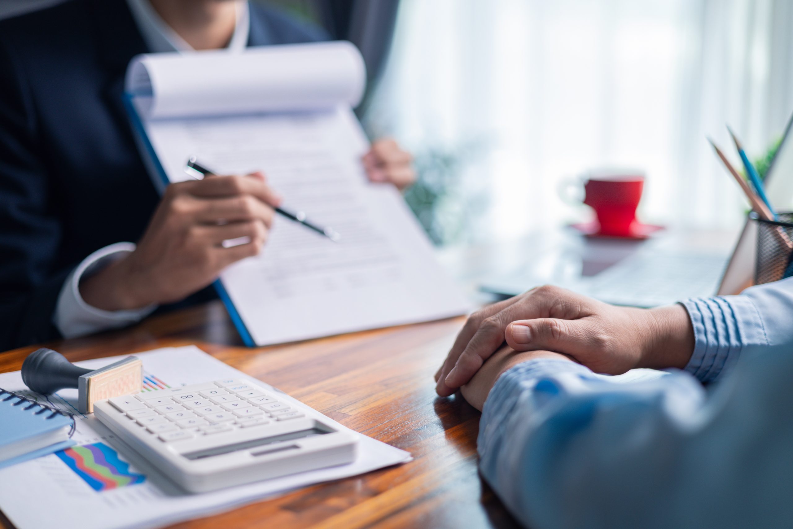 A loan officer running through the renovation loan contract with the borrower in detail