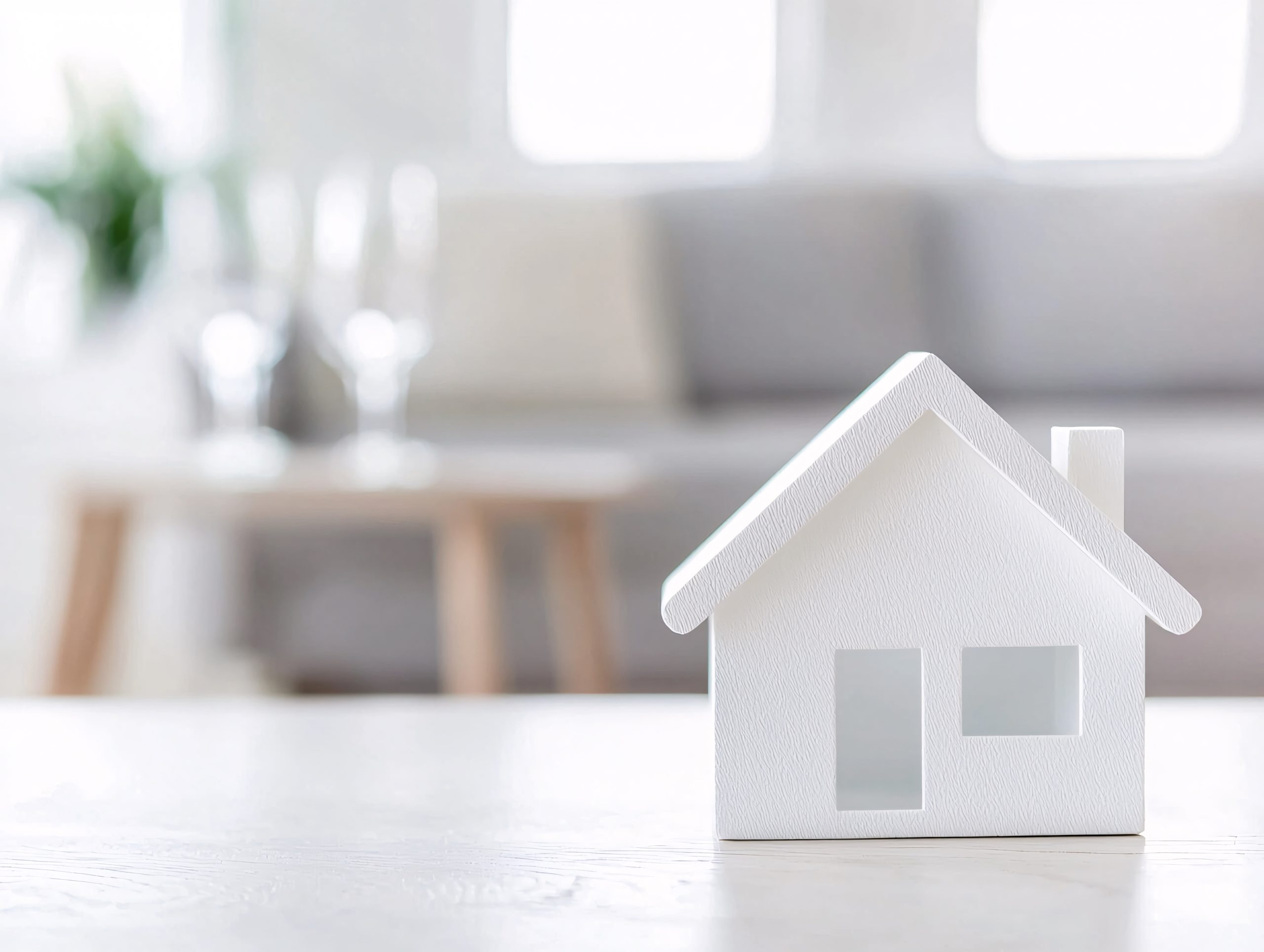 A small house model on the table signifying collateral for a secured personal loan application