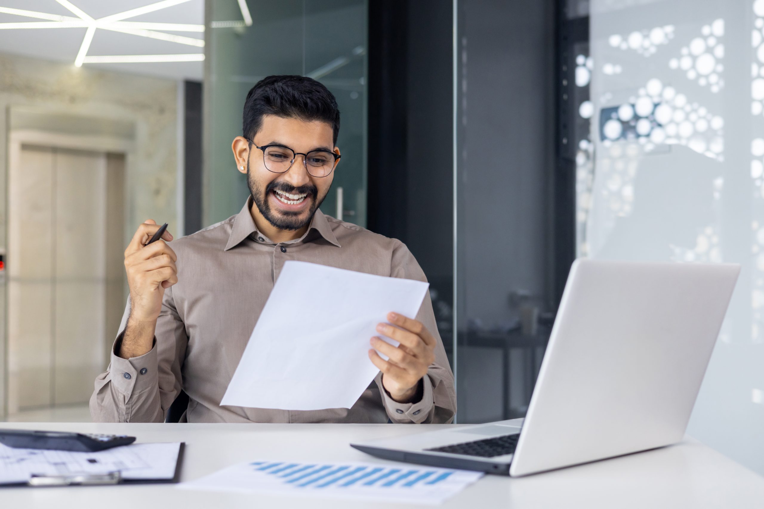 An asian man brimming with joy after a successful personal loan approval