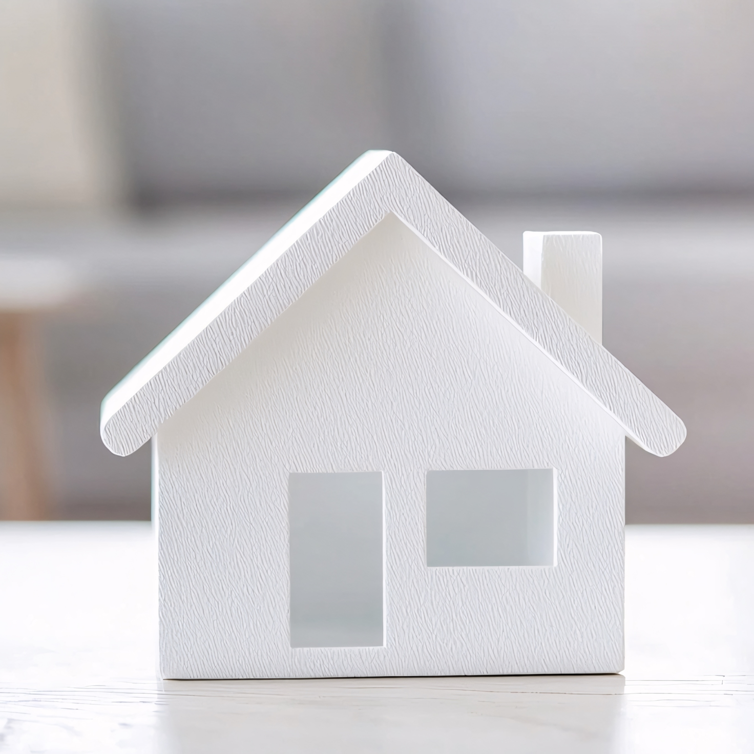 A small house model on the table signifying collateral for a secured personal loan application